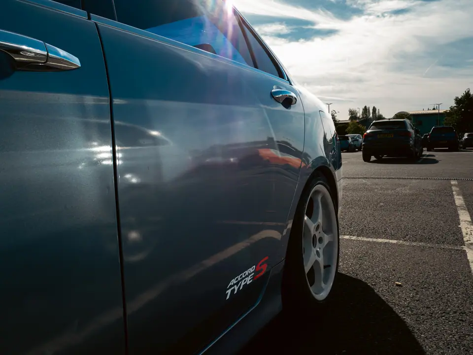 Sun flare along the flank of a grey Honda Accord Type S