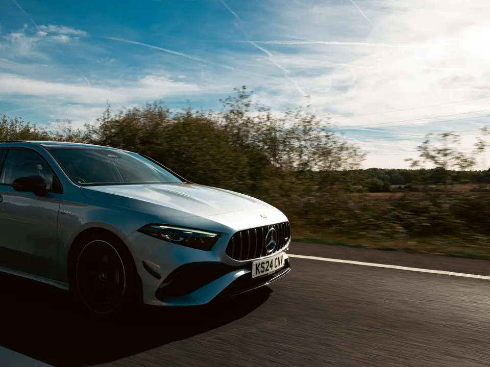 Silver Mercedes-AMG A-Class rolling under a big sky