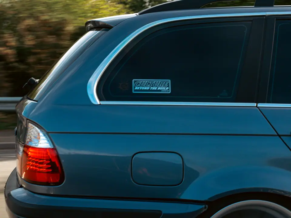 Culture Beyond The Build sticker on a blue BMW 3 Series Touring at speed