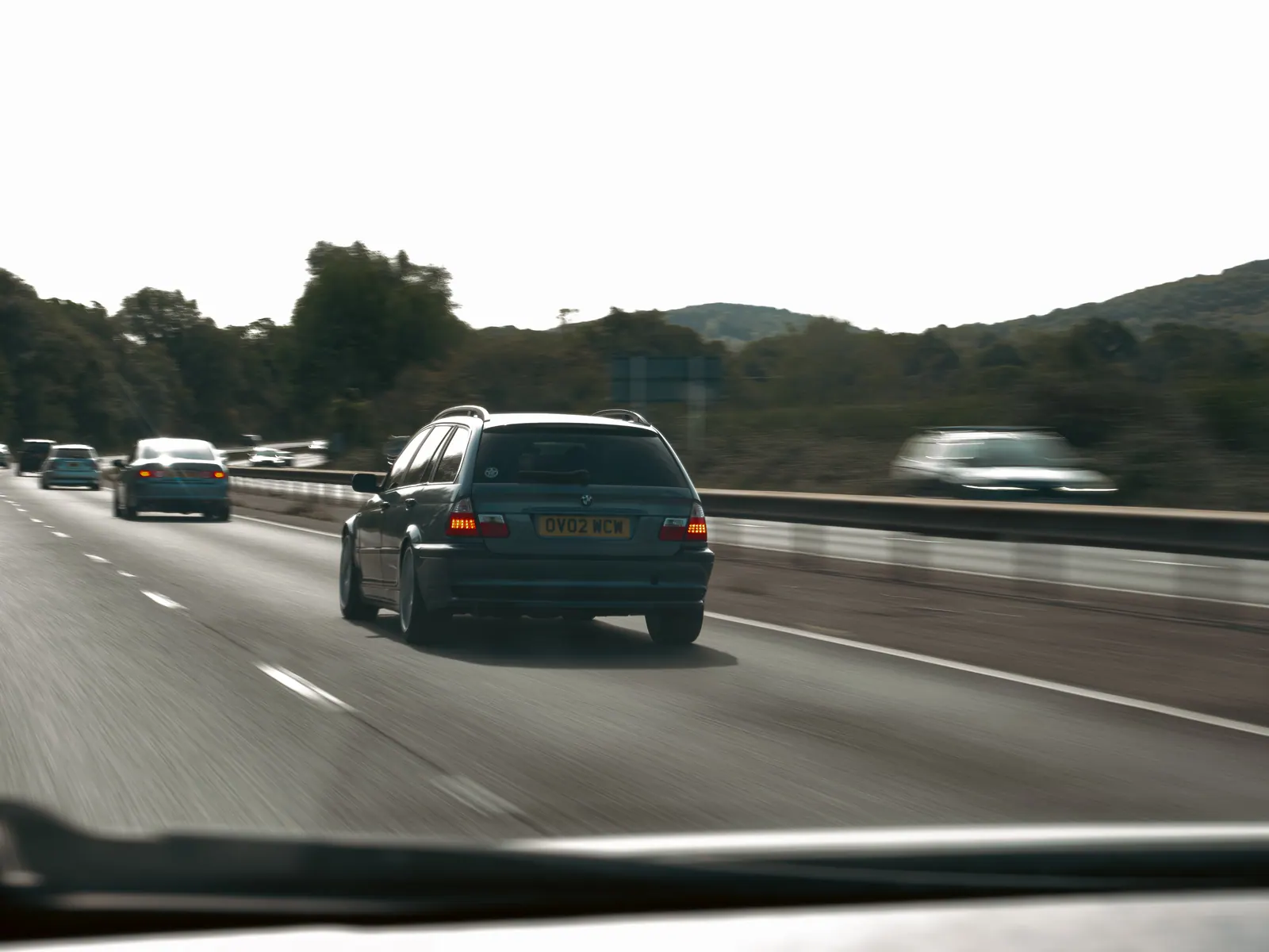 Blue BMW 3 Series Touring seen through the windscreen of the chase car