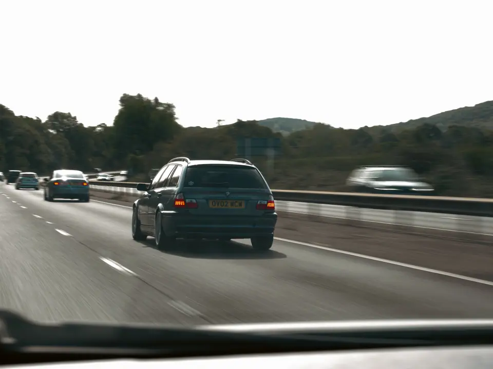 Blue BMW 3 Series Touring seen through the windscreen of the chase car