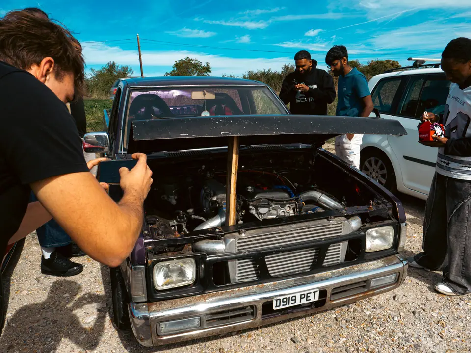 Turbocharged Nissan pick-up with its bonnet propped open on a stick