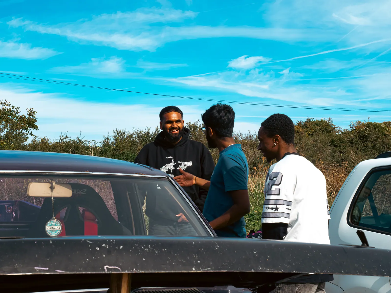 Laughing over the pick-up’s engine bay