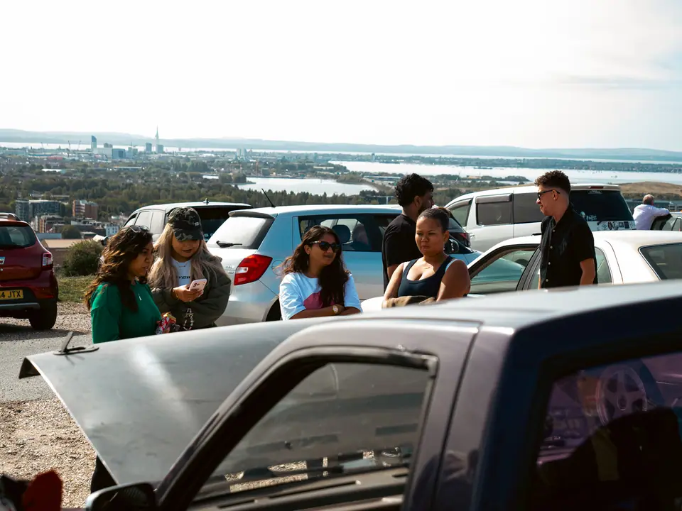 Friends chatting at the viewpoint over the city and harbour