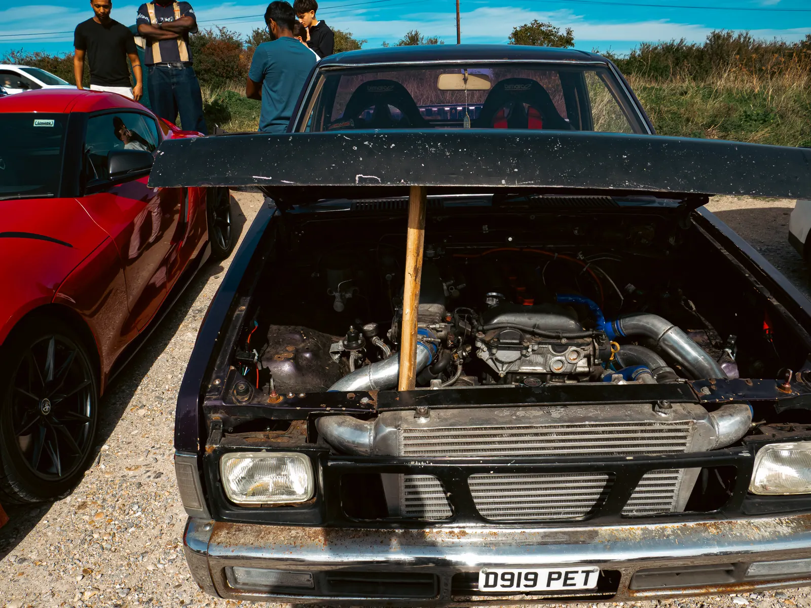 The pick-up’s engine bay with a red GR Supra alongside