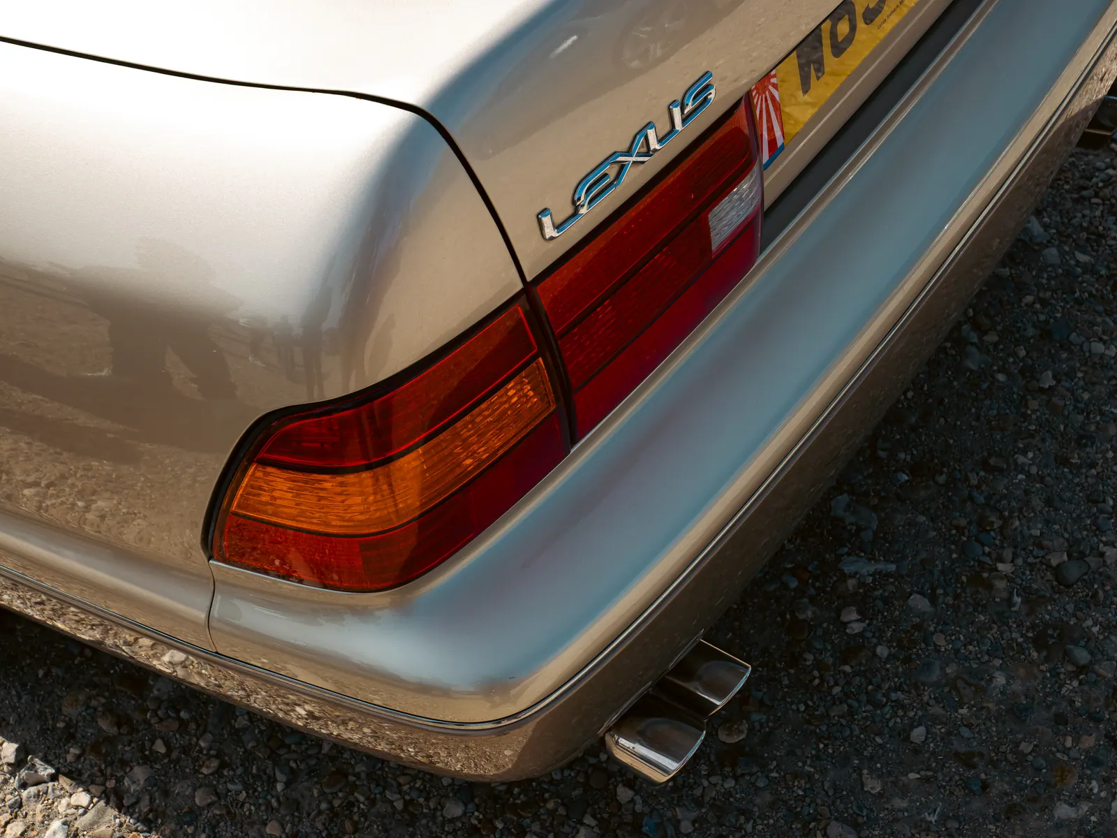 LEXUS lettering and tail light on a gold Lexus LS