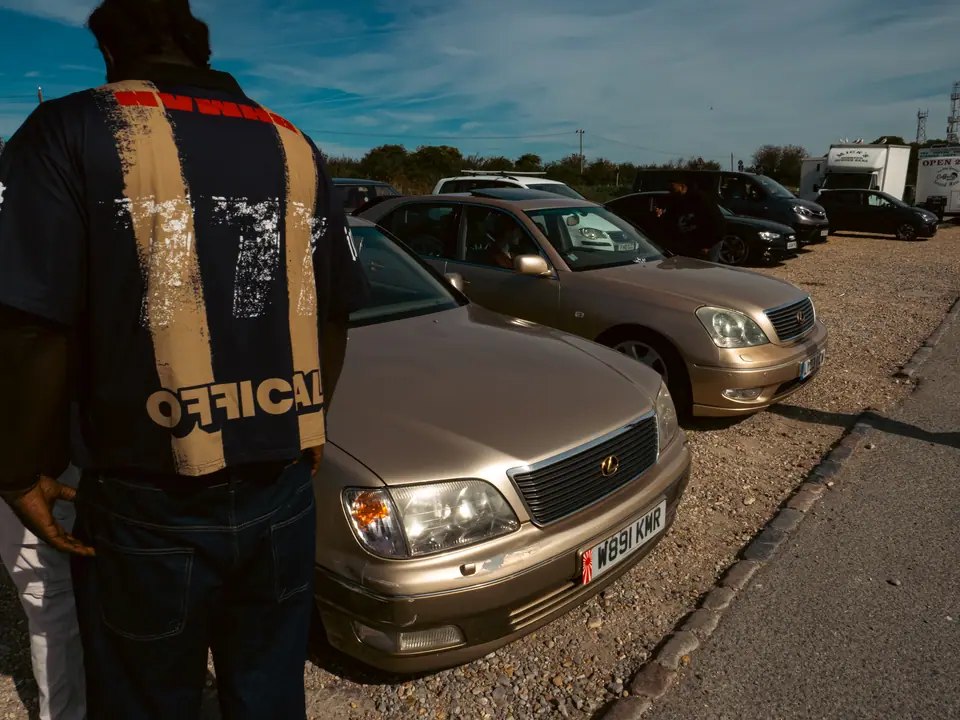 Gold Lexus LS saloons lined up on the gravel