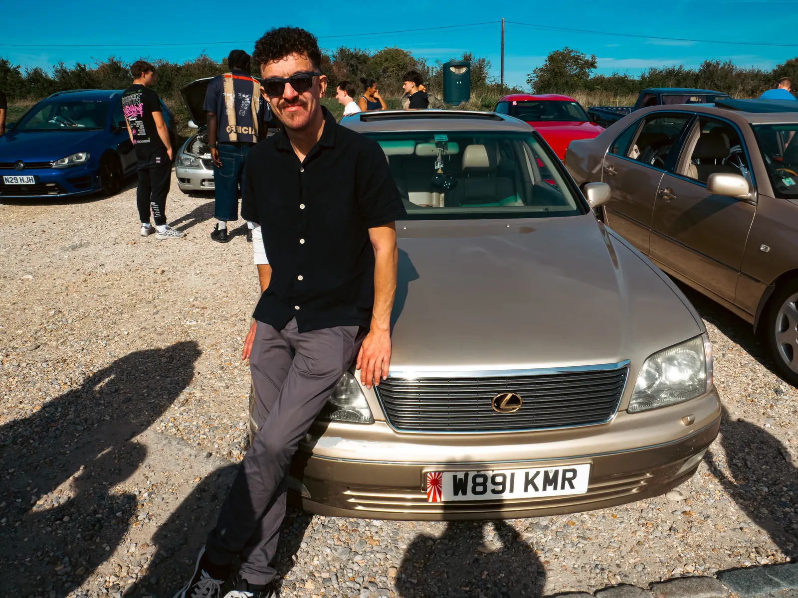 Sitting on the bonnet of a gold Lexus LS