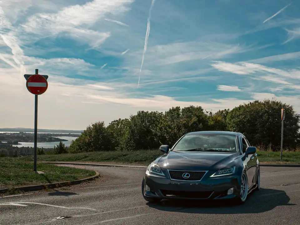Black Lexus IS rounding the corner