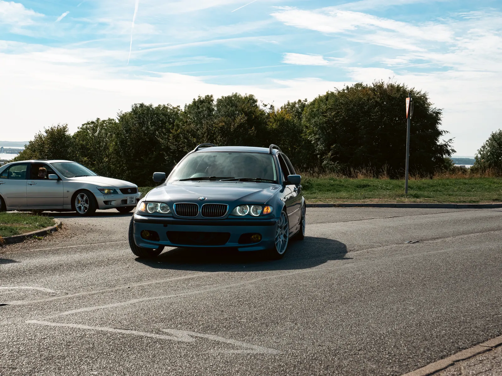 Blue BMW 3 Series Touring with angel-eye headlights
