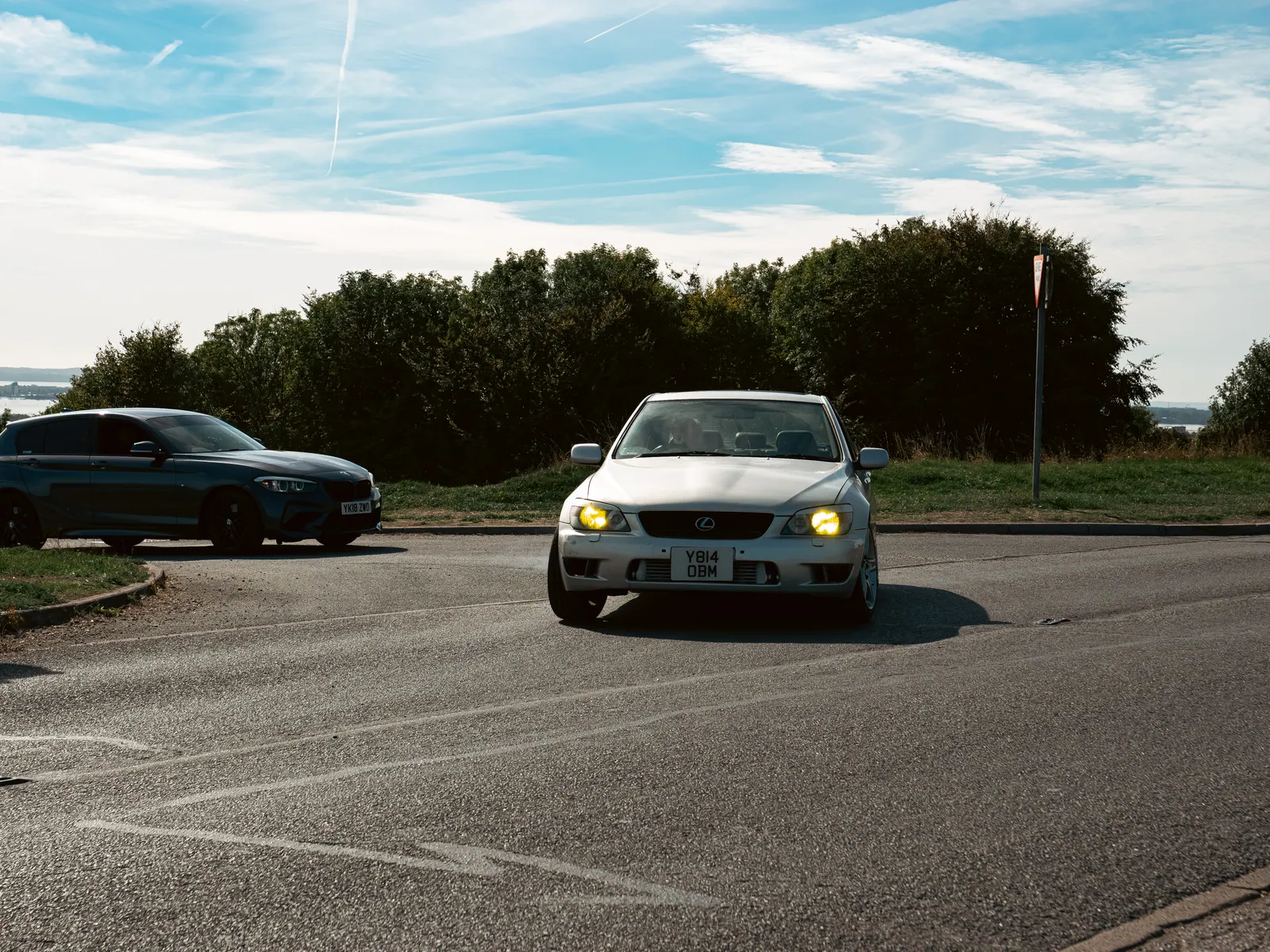 Silver Lexus IS with yellow fog lights