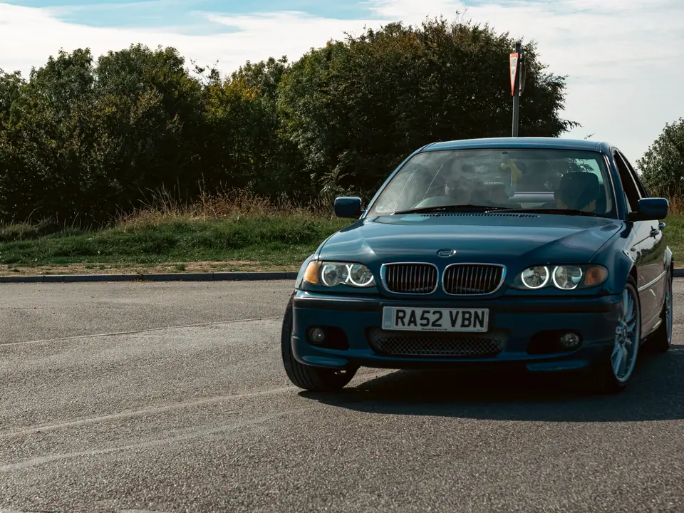 Blue BMW 3 Series saloon on the turn