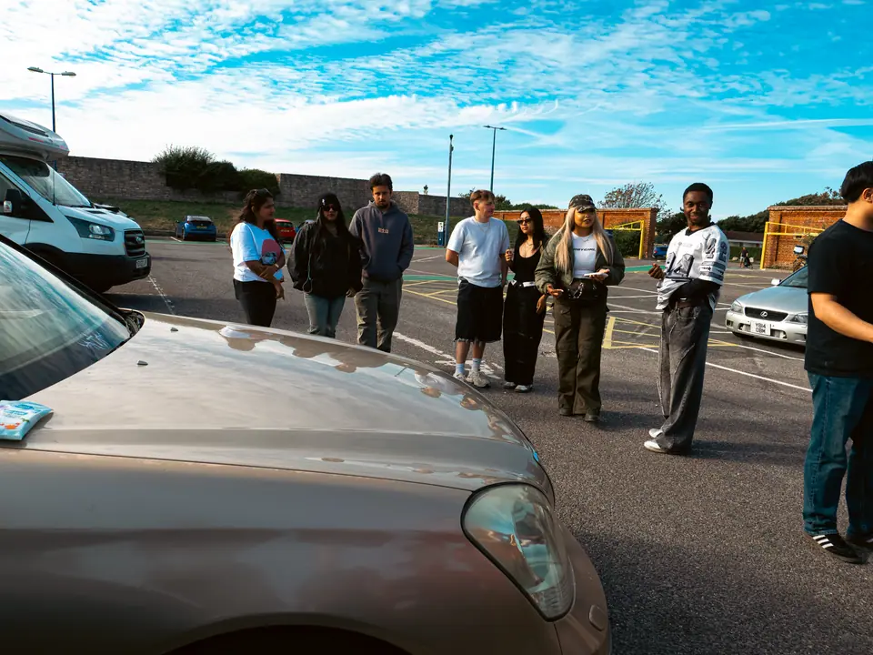 The gold Lexus LS with the crowd behind