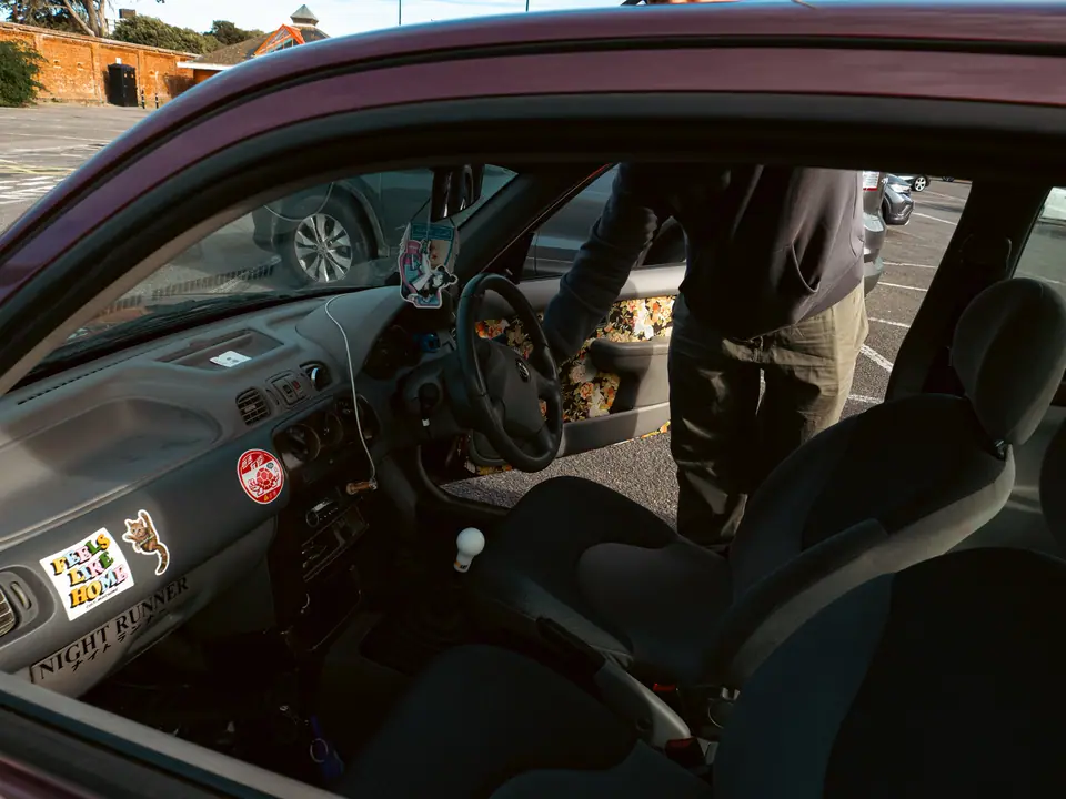 Sticker-covered dashboard inside the Nissan Micra