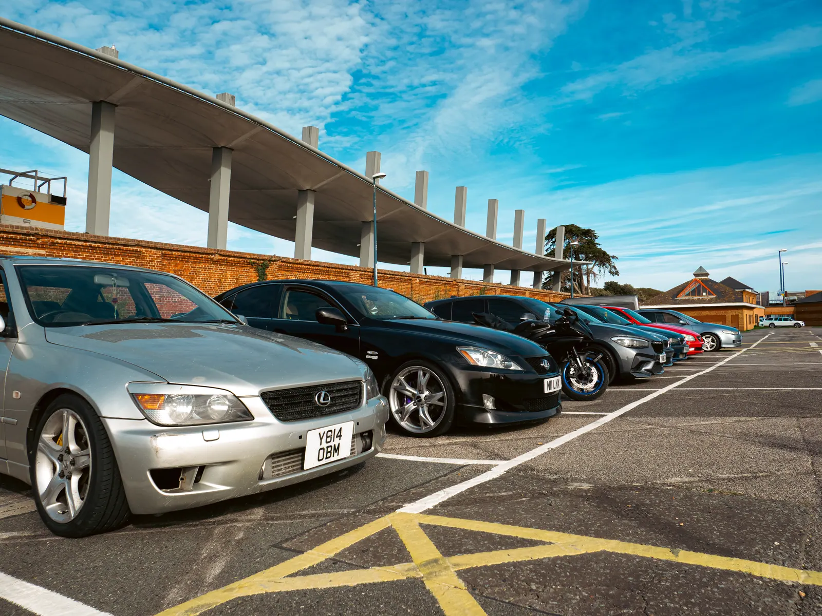 Silver and black Lexus IS lined up under the concrete canopy