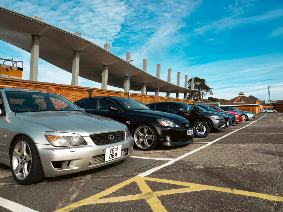 Silver and black Lexus IS lined up under the concrete canopy