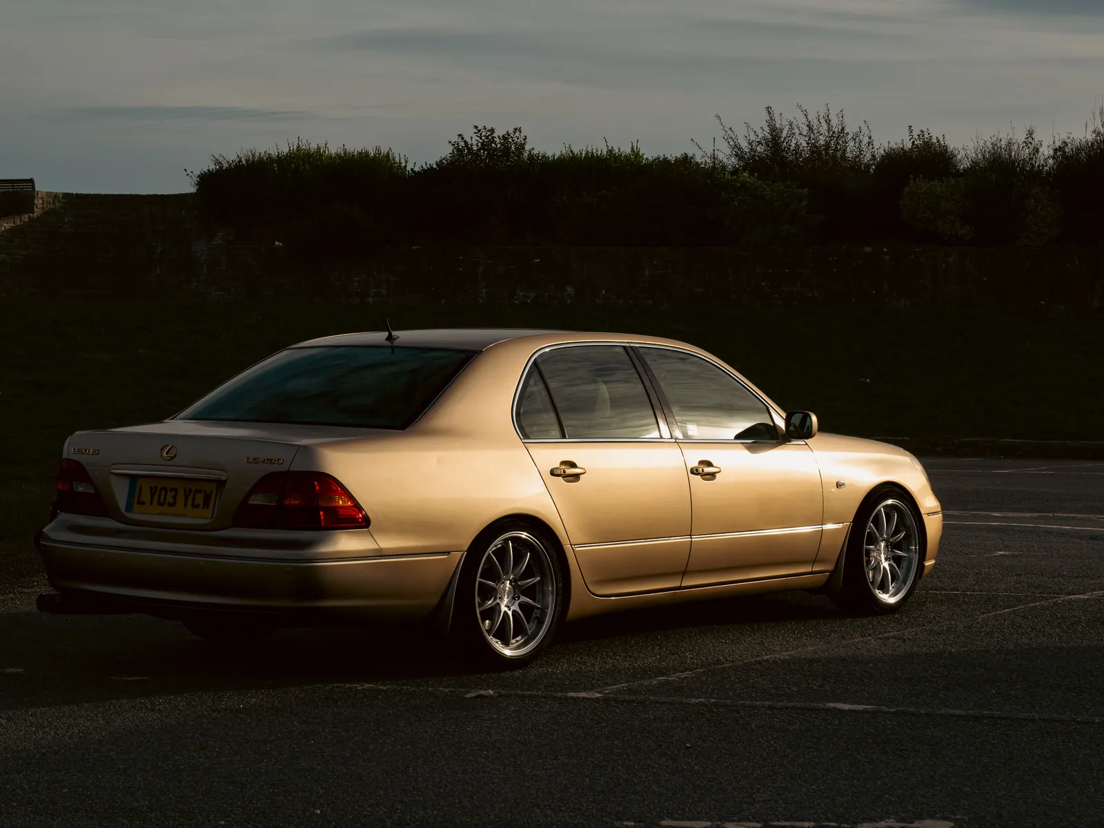 Gold Lexus LS in the last of the light