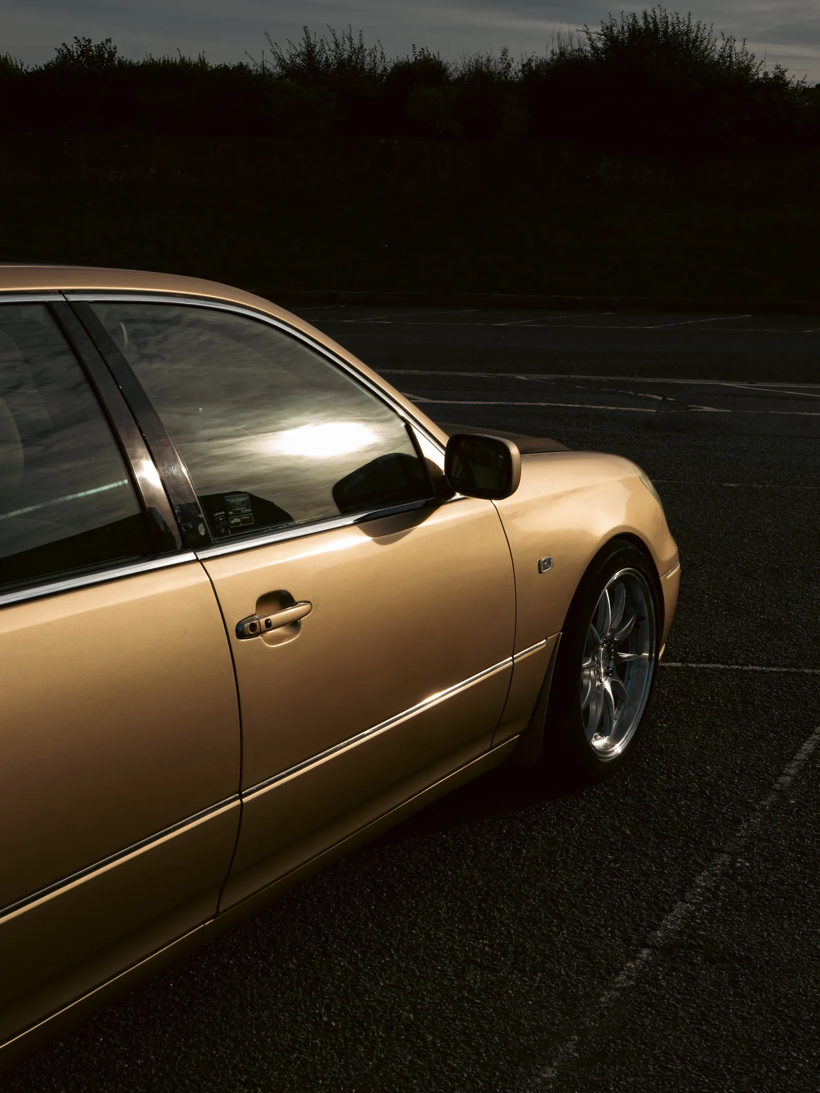 Gold Lexus LS at dusk, portrait