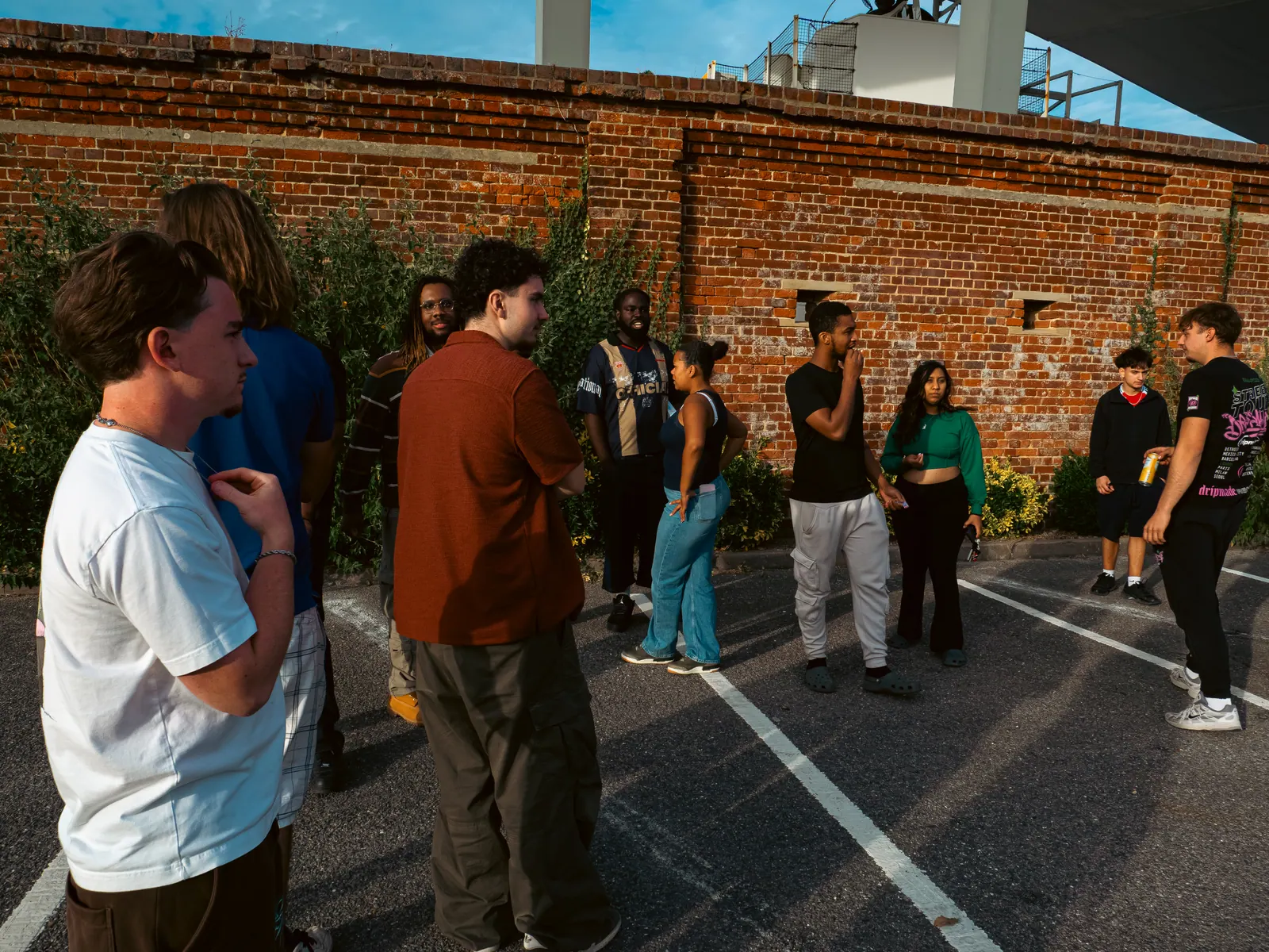 The crew against the red brick wall