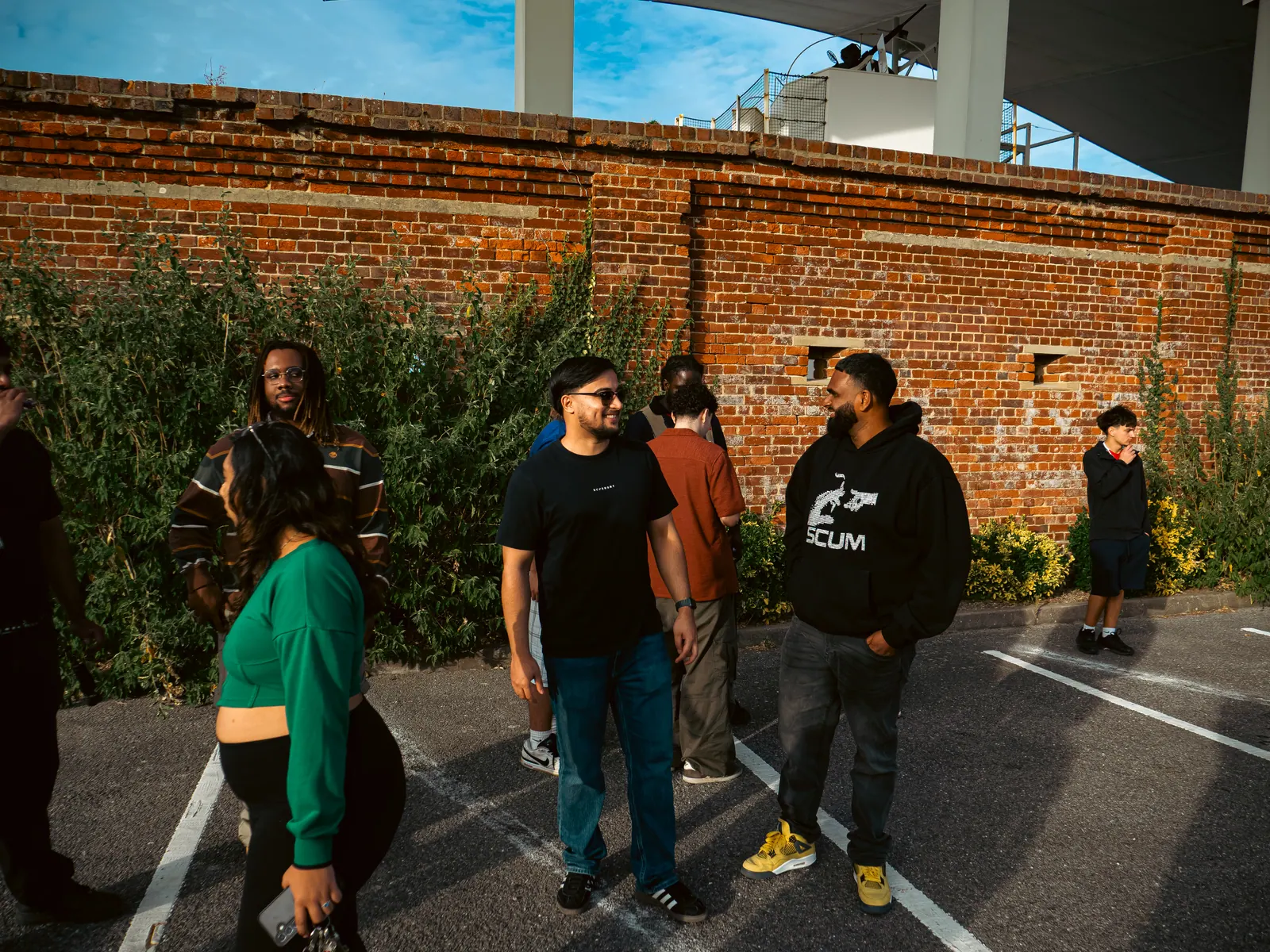 Friends standing by the brick wall
