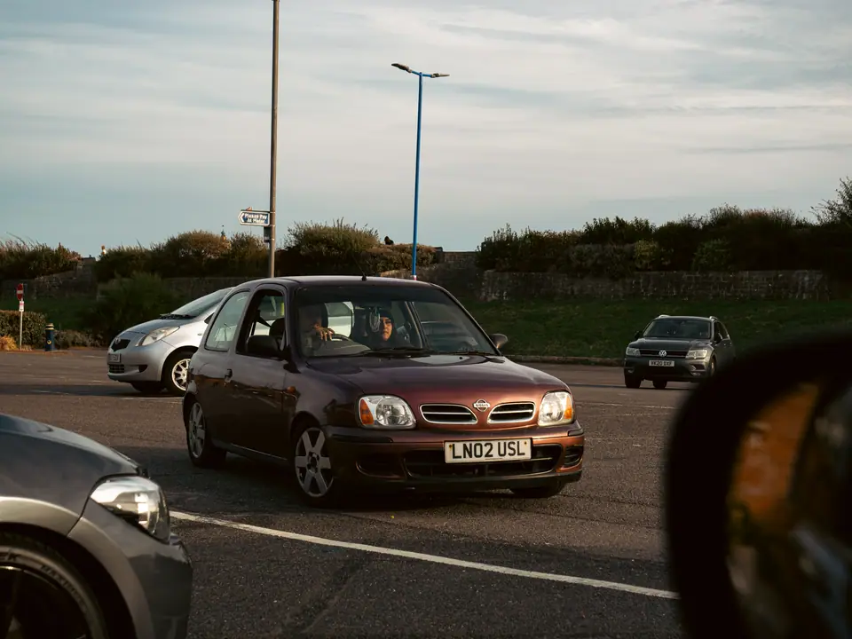 Purple Nissan Micra seen from the chase car