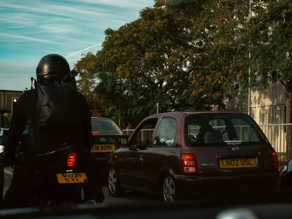 Motorcyclist and the purple Micra waiting at the lights
