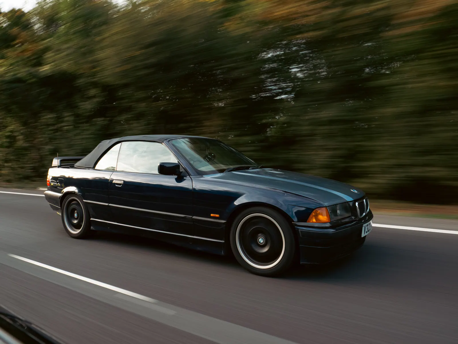 Dark blue BMW 3 Series Convertible rolling
