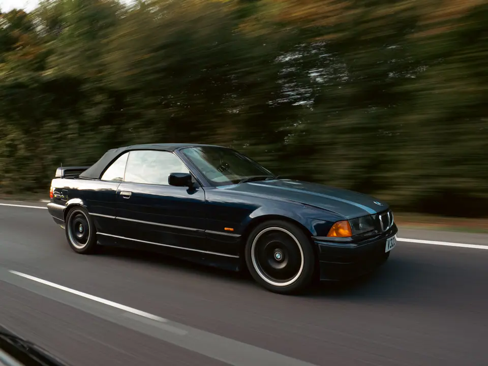 Dark blue BMW 3 Series Convertible rolling