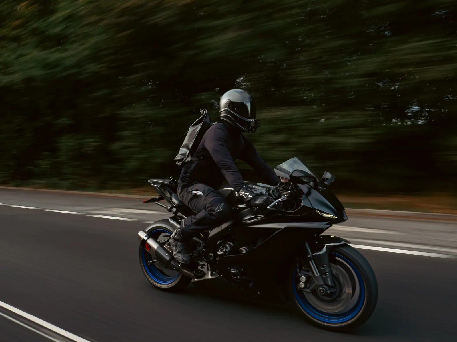 Black sports bike tracking close alongside