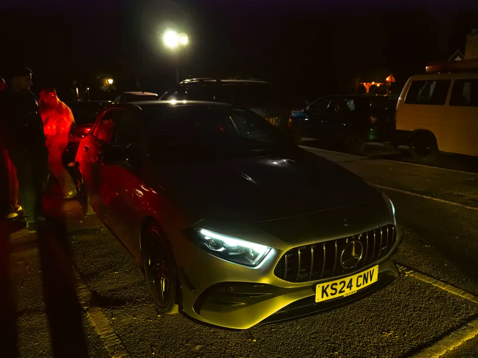 Silver Mercedes-AMG A-Class under a street lamp