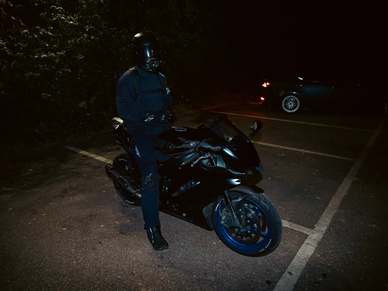 Rider and sports bike under flash