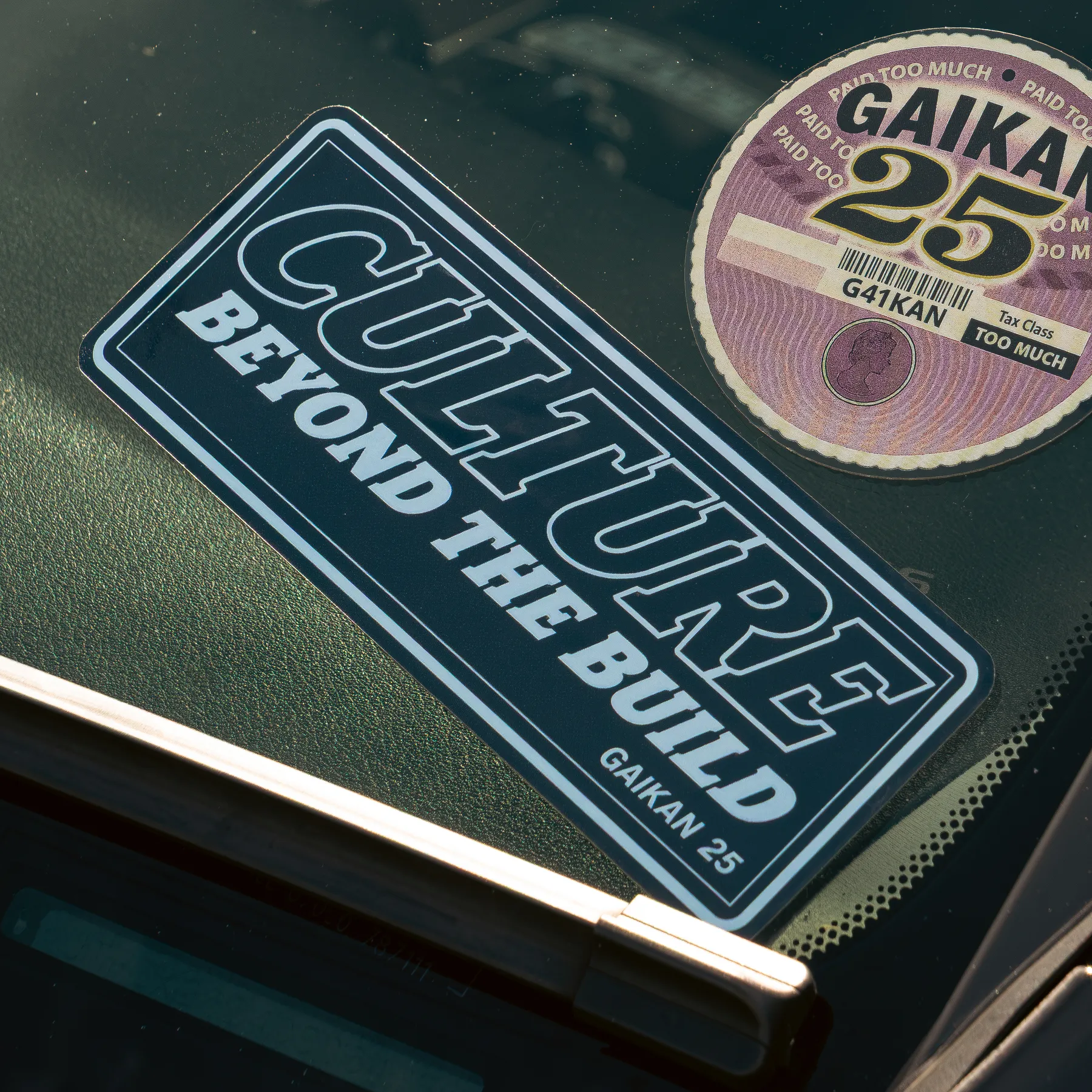 The sticker on a car windscreen next to the GAIKAN 25 tax disc sticker