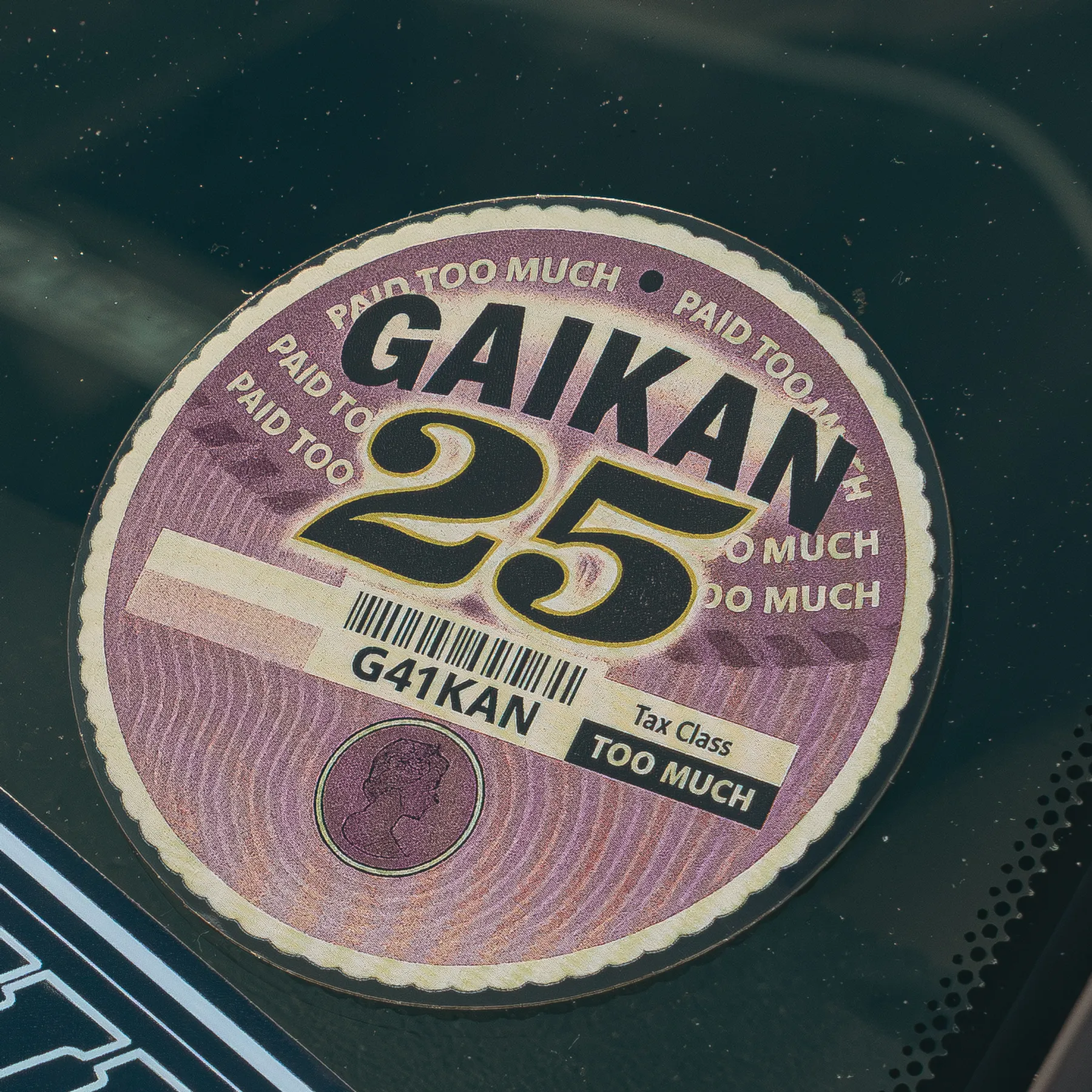The tax disc sticker on a car windscreen